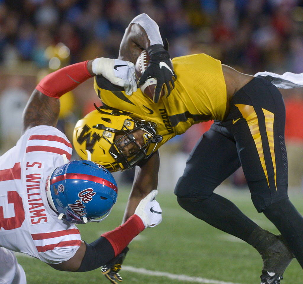 Missouri's Tyler Badie hits Ole Miss linebacker Sam Williams after a run